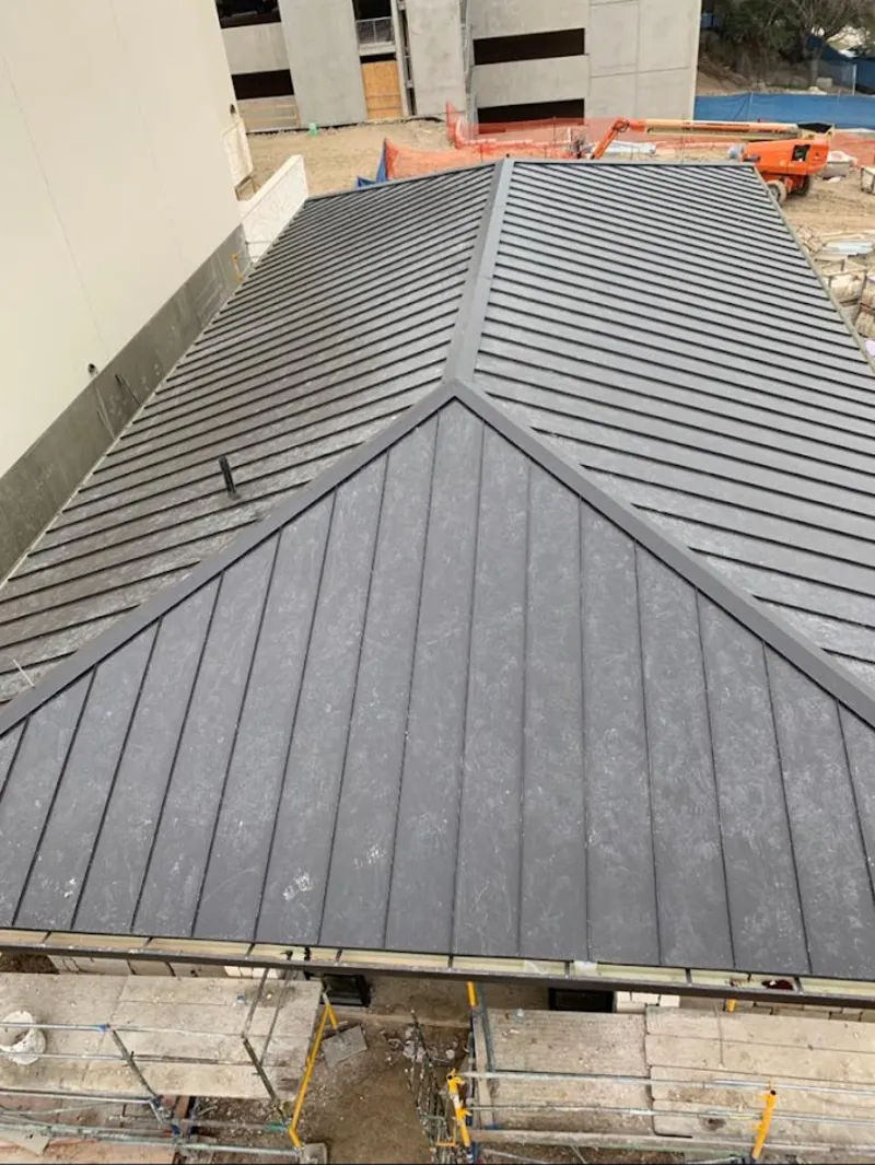 Commercial metal roof construction with crane equipment in Waimanalo
