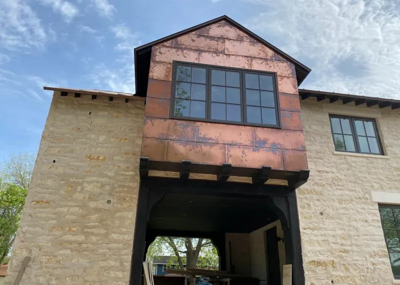 Copper metal panel facade on a stone building for Skylight Installation in Waimanalo